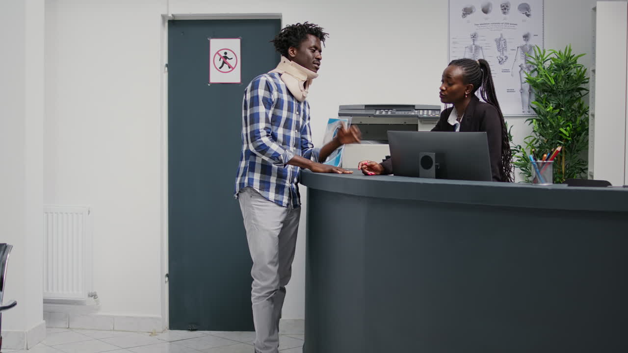 African american man wearing cervical neck collar in waiting room