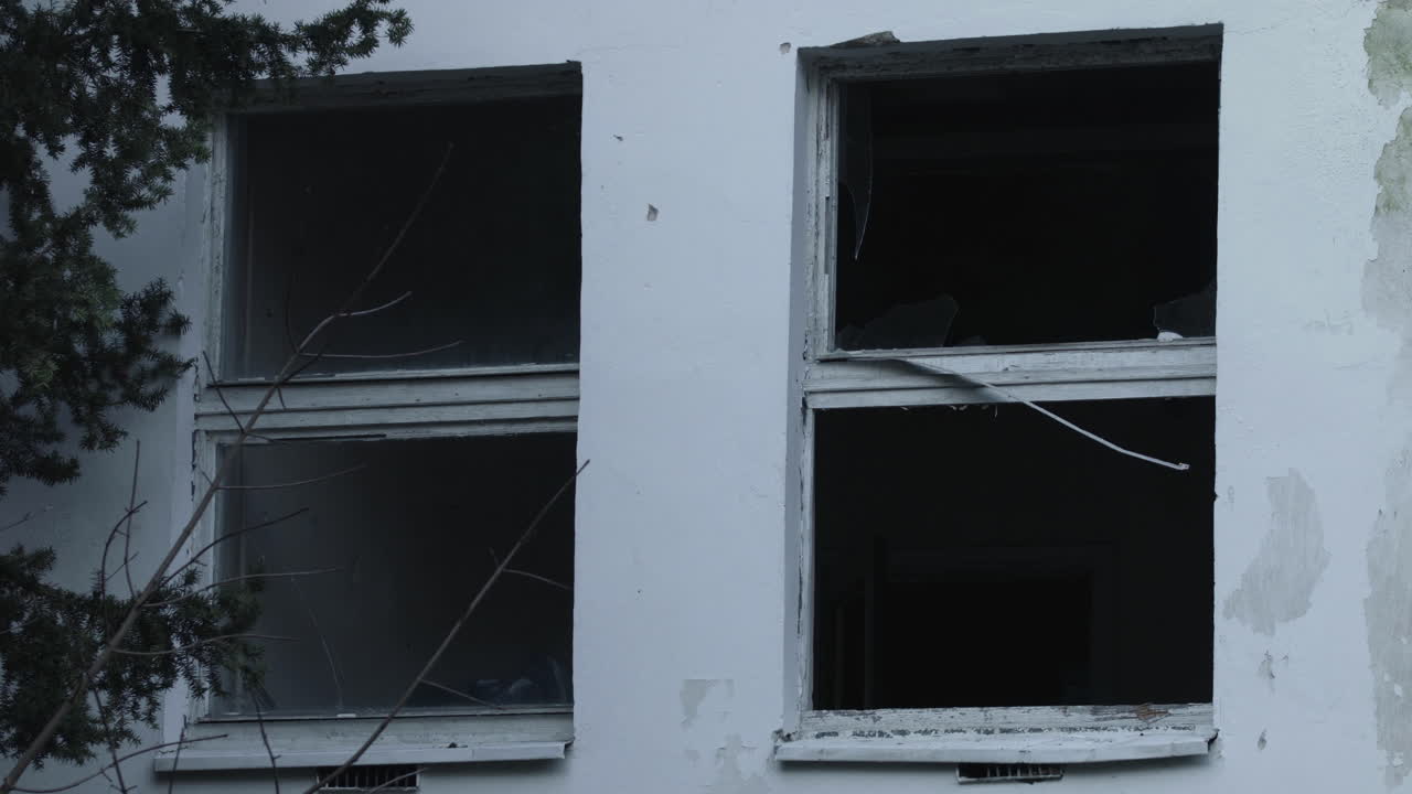 Broken windows in an old destroyed and abandoned building