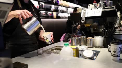 barista preparing a latte at a coffee shop