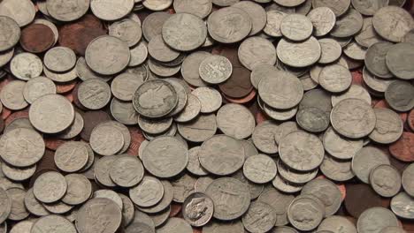 a pile of american coins lies spread out on a surface