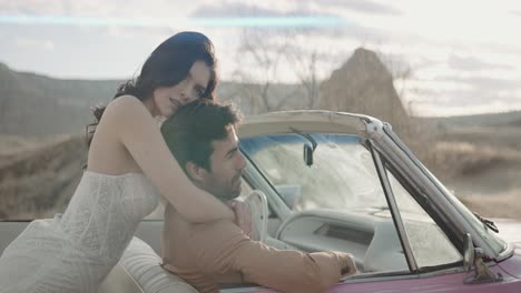 romantic couple in a vintage convertible