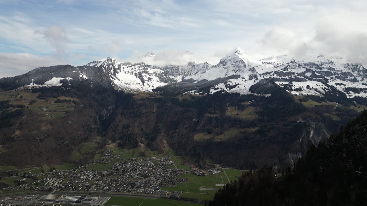 una vista aérea de glarus, la capital del cantón más pequeño de suiza, enclavada en medio de las montañas a la base de la cresta de glarnisch, rodeada de picos nevados, que exuda el atractivo de los alpes suizos