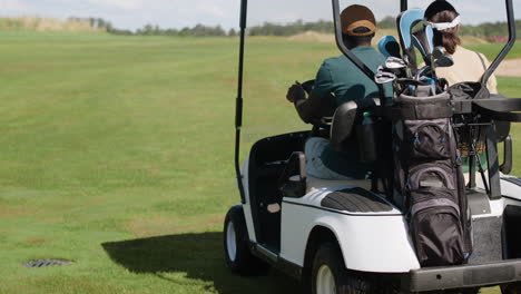 caucasian woman and african american man on the golf course.