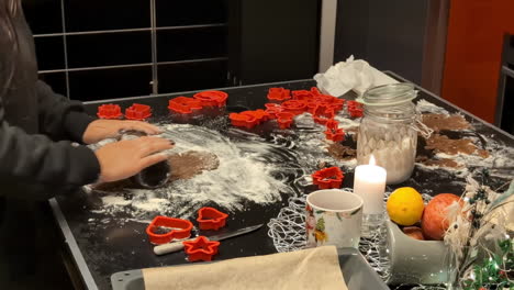 Woman-uses-beer-bottle-to-roll-out-gingerbread-cookie-christmas-dough-on-floured-surface