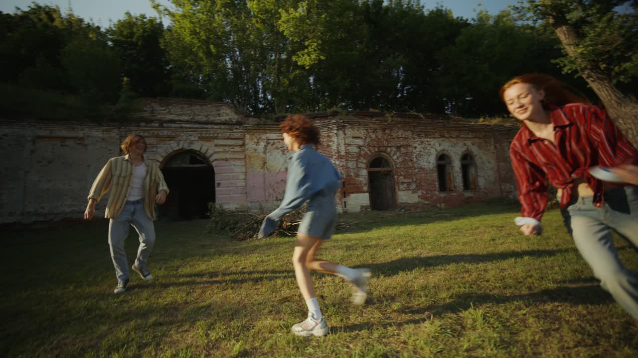 폐허 근처의 공원에서 달리는 친구들