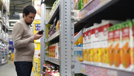 man shopping for drinks in a grocery store