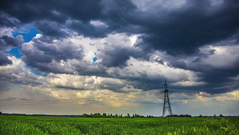 grey clouds over rural power grid system electricity lines in open field