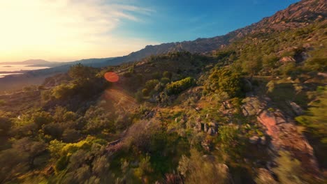 fpv drone flying over beautiful mountains at sunset