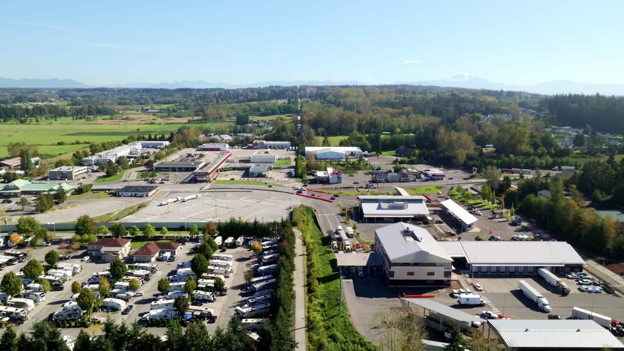 Vehicles Navigate Through Several Checkpoint Lanes at the Bustling Border Crossing Between South Surrey, BC, and Blaine, WA - Drone Flying Forward