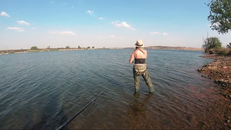 beautiful girl fishing at a calm lake on a sunny day in south africa