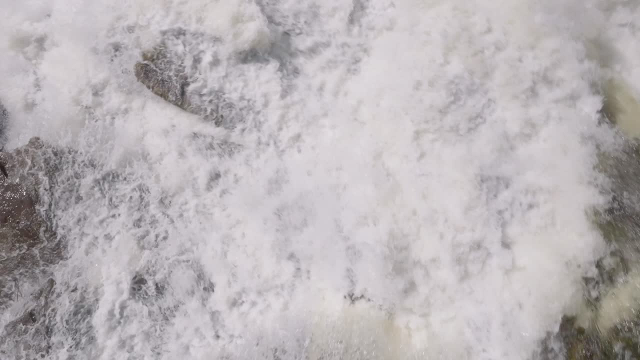 Turbulent river waters flow swiftly creating a mesmerizing pattern in Owen Sound, Canada