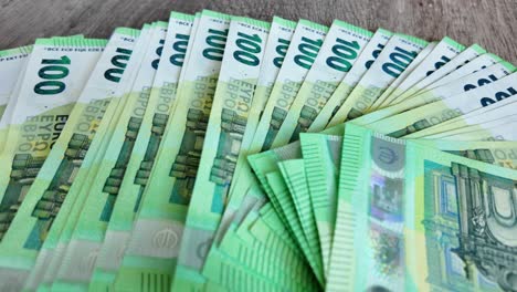 in einer verzögerungsvideo-aufnahme liegen entfaltete euro-banknoten auf dem tisch ausgebreitet