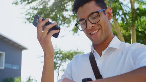 Man-checking-time-while-talking-on-mobile-phone-4k