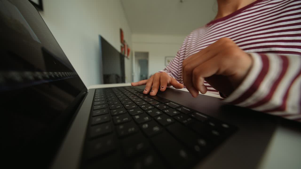 Woman's Hands Typing on Laptop Keyboard and Using Trackpad
