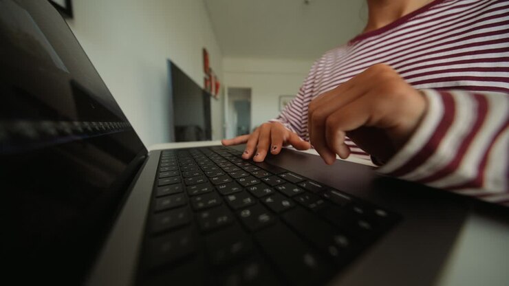 Woman's Hands Typing on Laptop Keyboard and Using Trackpad