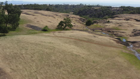 narrow hiking path trail winds over grassland around oroville, california