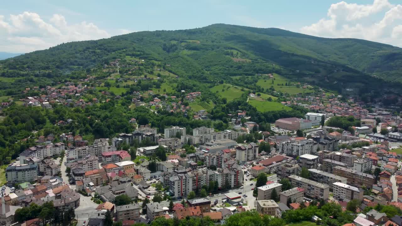 Aerial drone footage of Travnik, Bosnia and Herzegovina, capturing the historic Old Town, Stari Grad fortress, and the surrounding mountain landscape