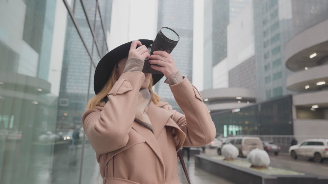 Woman Taking Pictures in a Cityscape during Winter