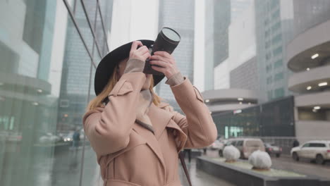 woman taking pictures in a cityscape during winter
