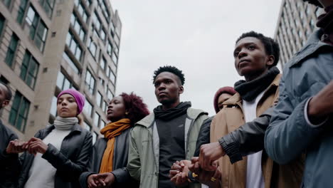 diverse group of people holding hands in a show of unity and solidarity