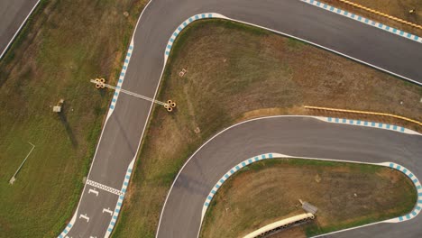 Lowering-top-down-aerial-of-a-go-kart-track-in-Spain