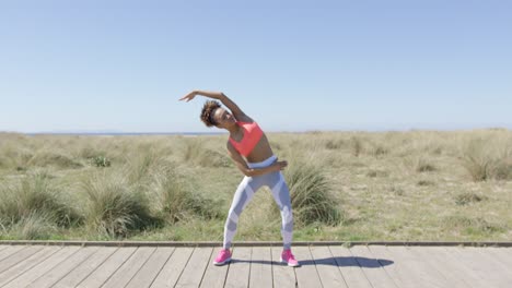 Sporty-woman-stretching-on-pavement