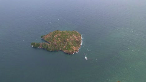 drone shot of an islet in the middle of an ocean