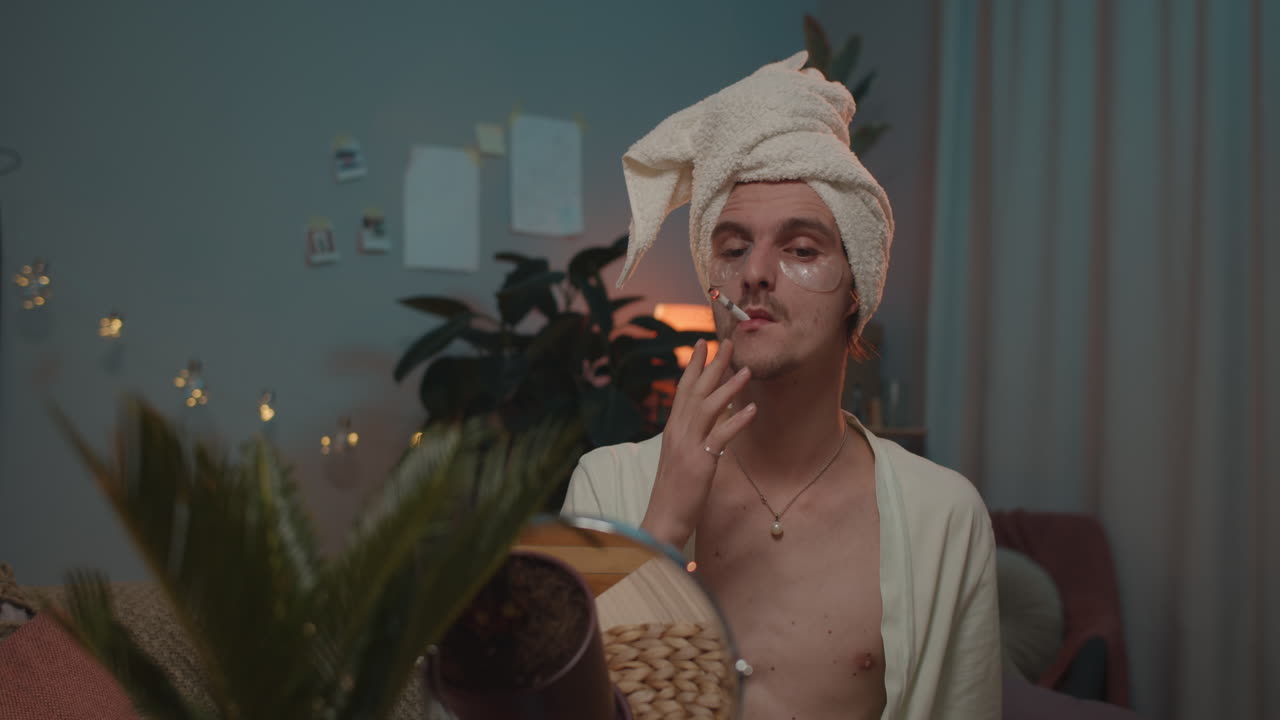 Man with towel on head smoking a cigarette
