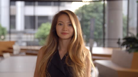 young asian businesswoman walking into focal plane