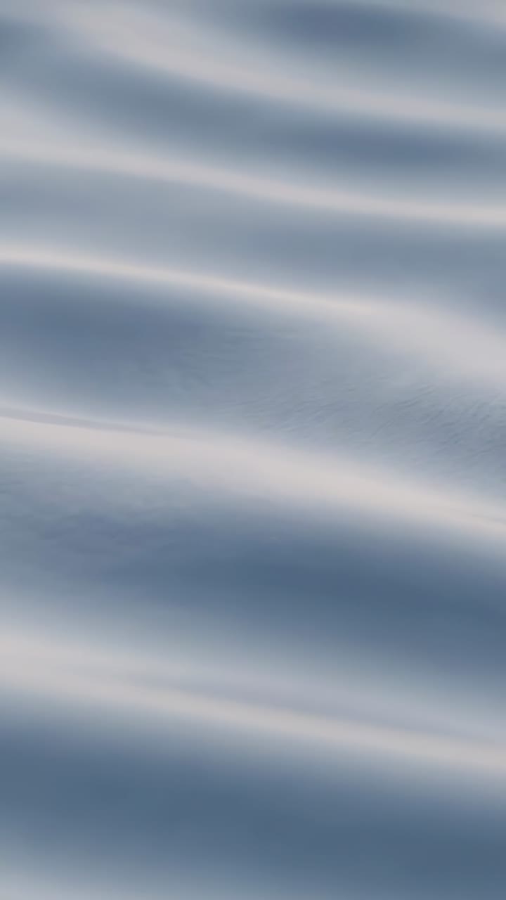 Vertical video: Recording breeze moving calm water in portrait closeup with parallel ripples