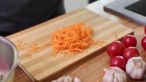 grating carrots on a cutting board