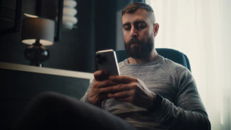 top view of anonymous mature male analyst in blue suit sitting at desk in corporate office, working on financial report on laptop, studying numbers and data on graphs and charts