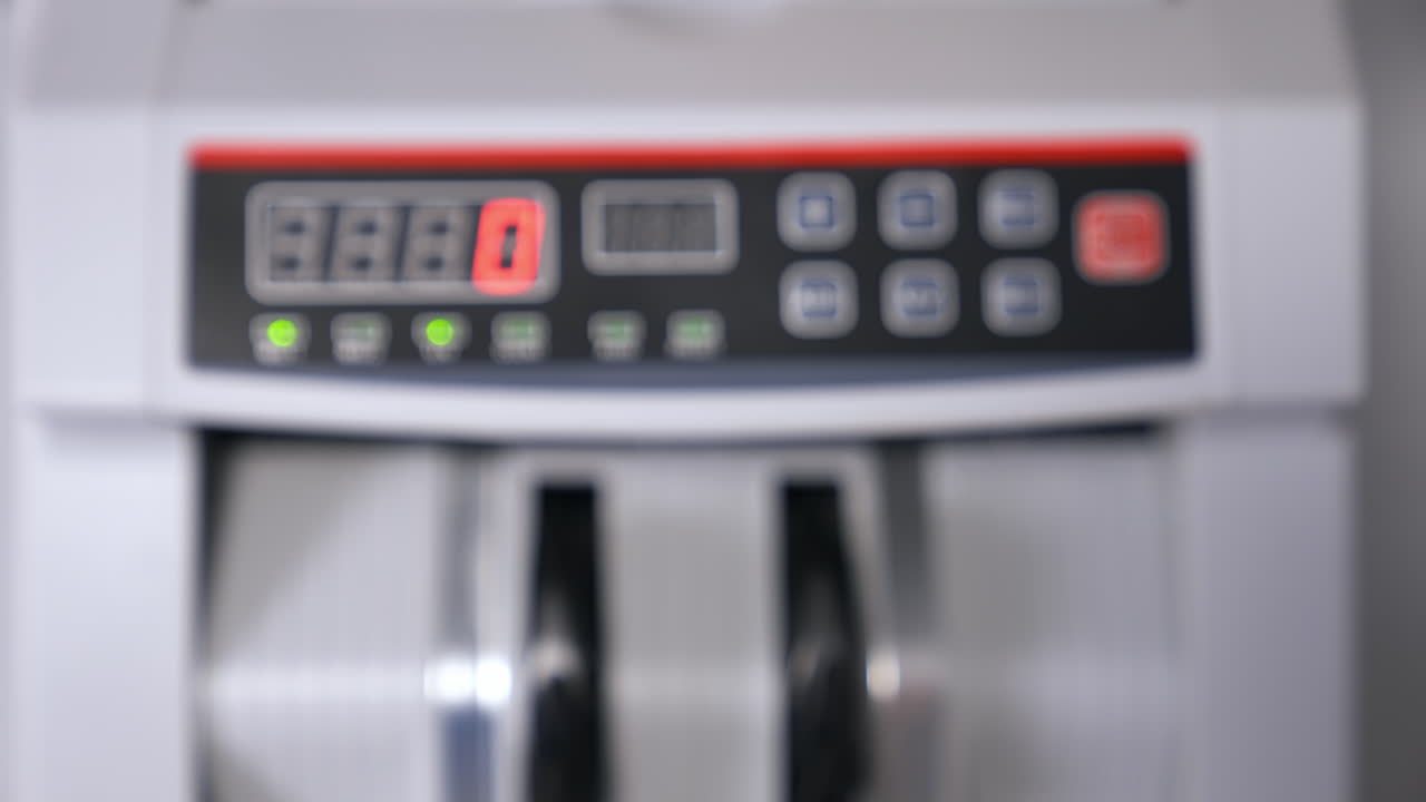 Modern electronic bill counter with money, closeup
