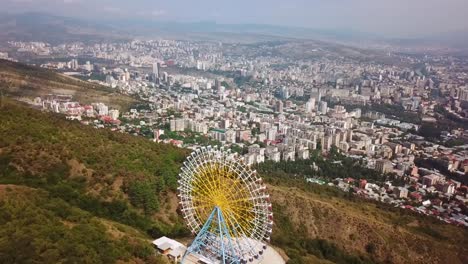 aerial around the tbilisi ferris wheel in the republic of georgia