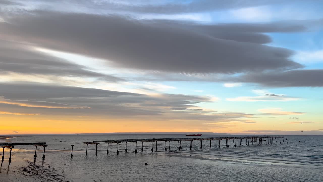 Morning calm chill sunrise view of the Magallanes Sea with the old pier in Punta Arenas, Chilean Patagonia