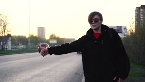 man waiting for a ride on the street