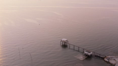 Aerial-view-of-fishing-huts-with-typical-italian-fishing-machine,-called-""trabucco"",Lido-di-Dante,-fiumi-uniti-Ravenna-near-Comacchio-valley