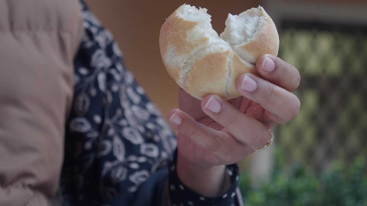 Woman holding a bread roll