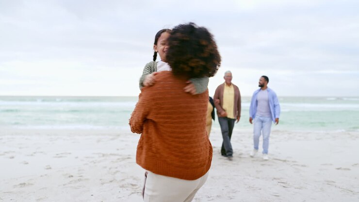 Family, happy and mother with child at beach
