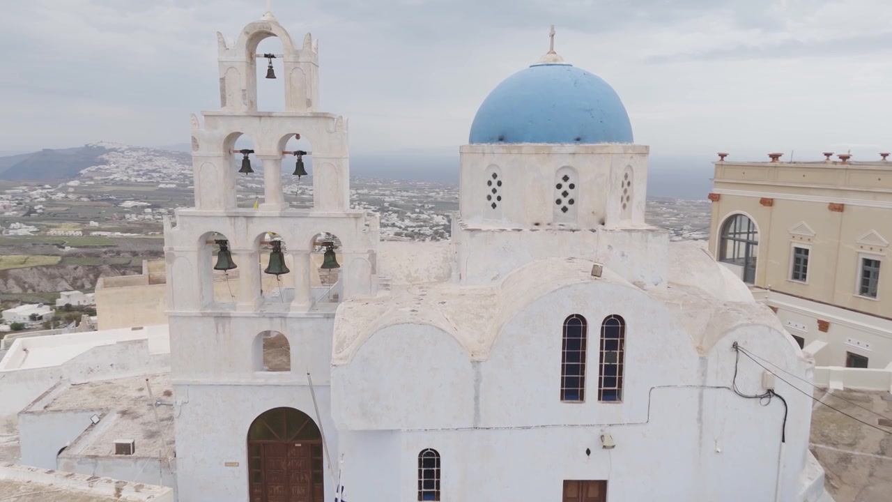 Aerial view of the traditional blue domed church of Agia Theodosia in the village of Pyrgos, Greece