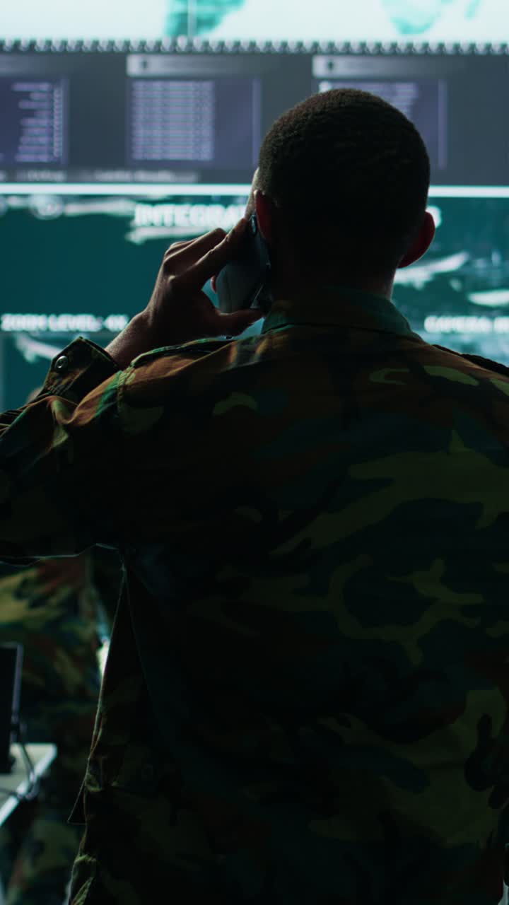Vertical Video Military man answers phone call in a mission control center