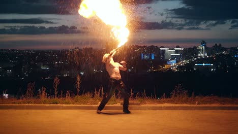 Young-blond-male-does-tricks-with-fire-Male-breaths-fireballs-multiple-times