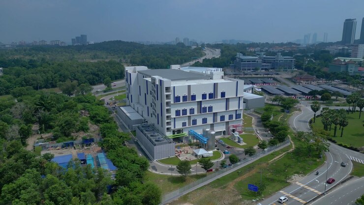 Modern architecture of a large data center facility in Kuala Lumpur, Malaysia, representing global network infrastructure and technology. Nice aerial view ascending raise up panorama drone