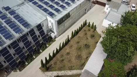 eco park solar installation, aerial tilt down shot over modern offices