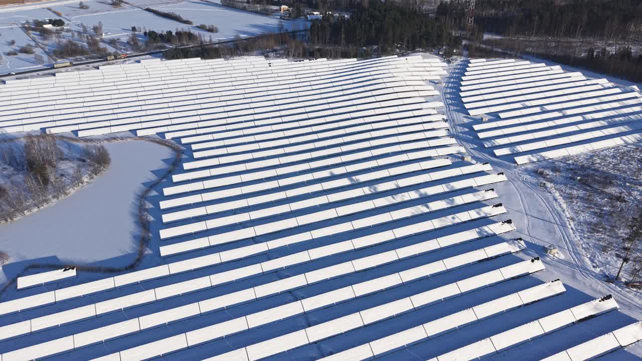 Snoede rækker af snedækkede solpaneler set ovenfra.