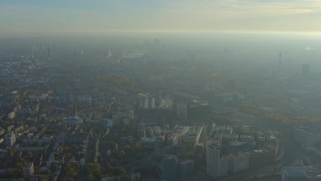 high aerial slider shot over kings cross industrial area looking towards central london