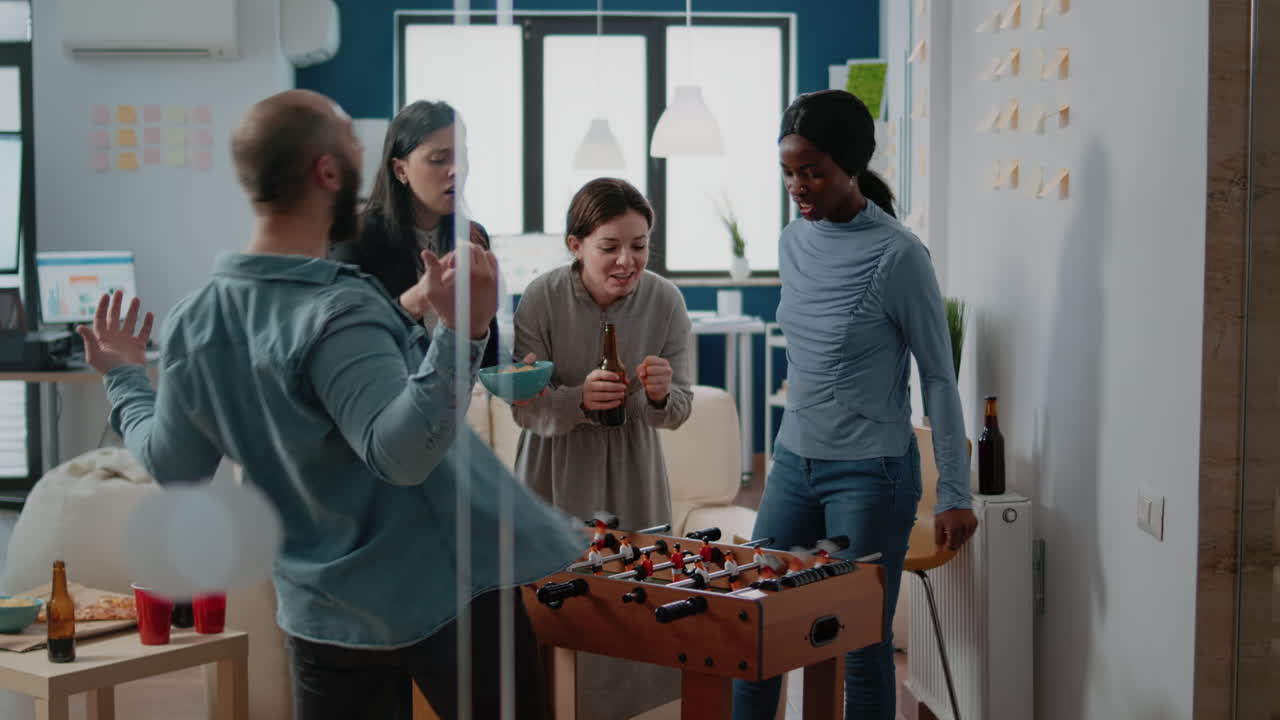 Businessman winning soccer game at foosball table