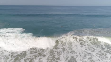 Aerial-shot-of-a-surfer-surfing-a-big-tube-barrel-wave-and-falling-in-Zicatela-beach-Puerto-Escondido,-Oaxaca