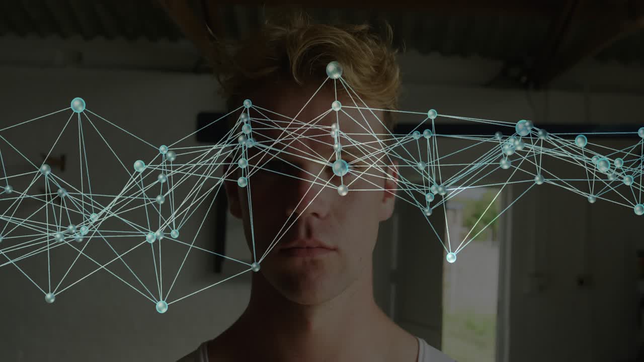 Man holding still nodes lines network appearing over eyes and sweeping across face, showing tech