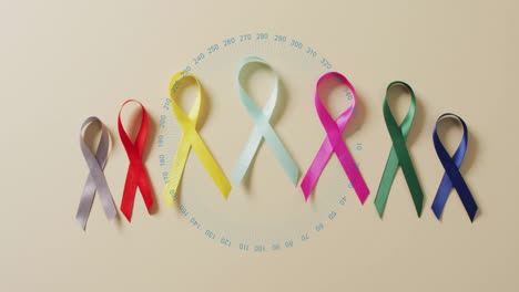 colorful awareness ribbons with circular data animation over beige background